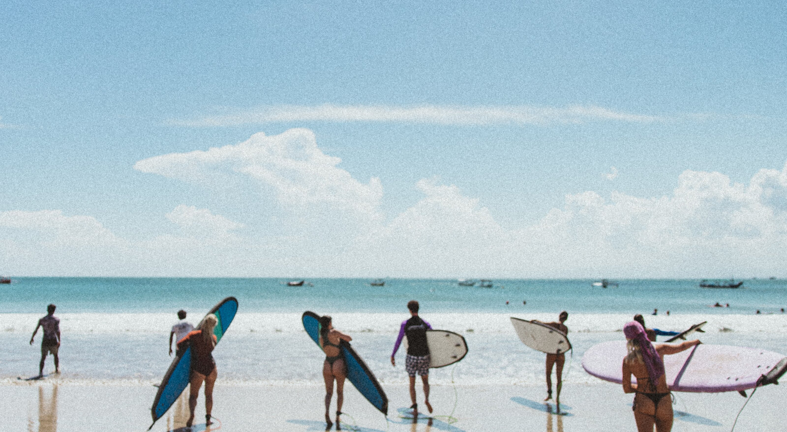 Walking out to the water with boards