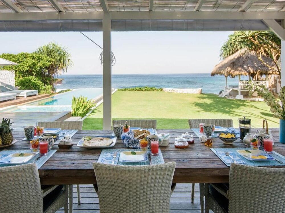 Breakfast table set by the pool
