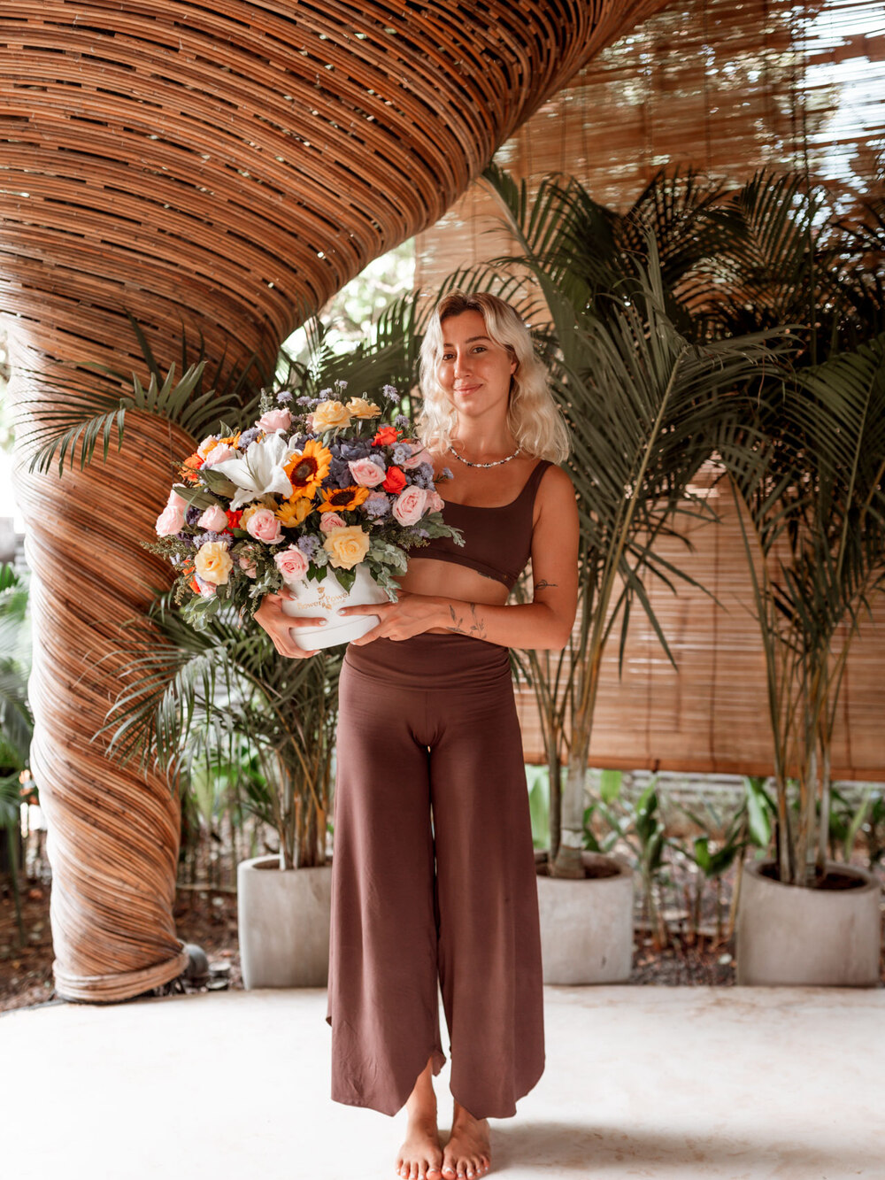 Ece holding a bouquet of flowers at the retreat